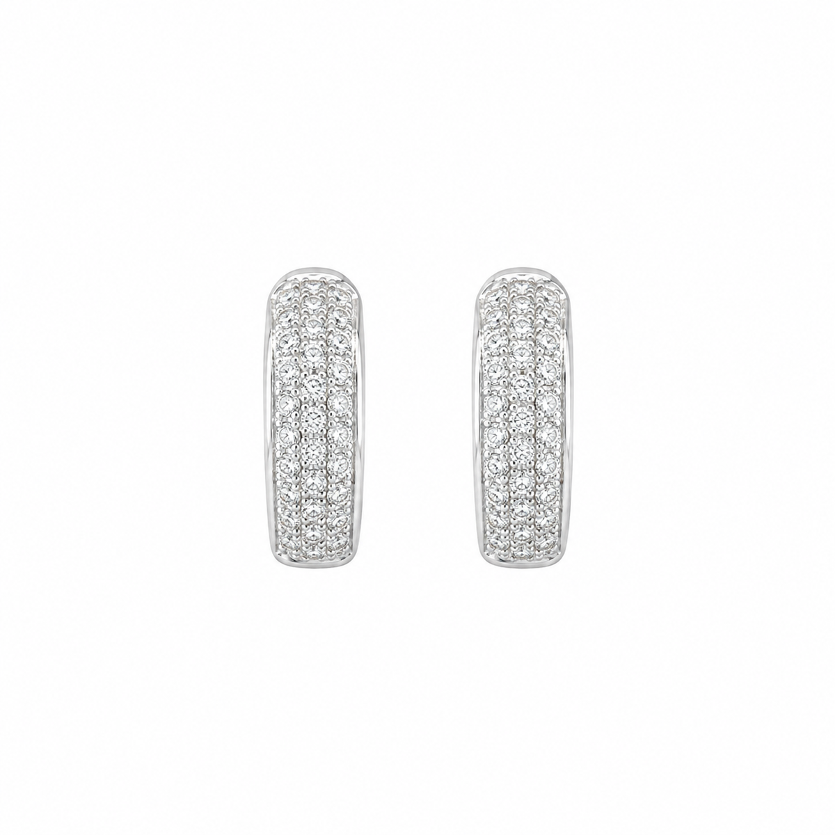 A pair of silver-toned hoop earrings paved with small clear stones, shown against a plain white background.