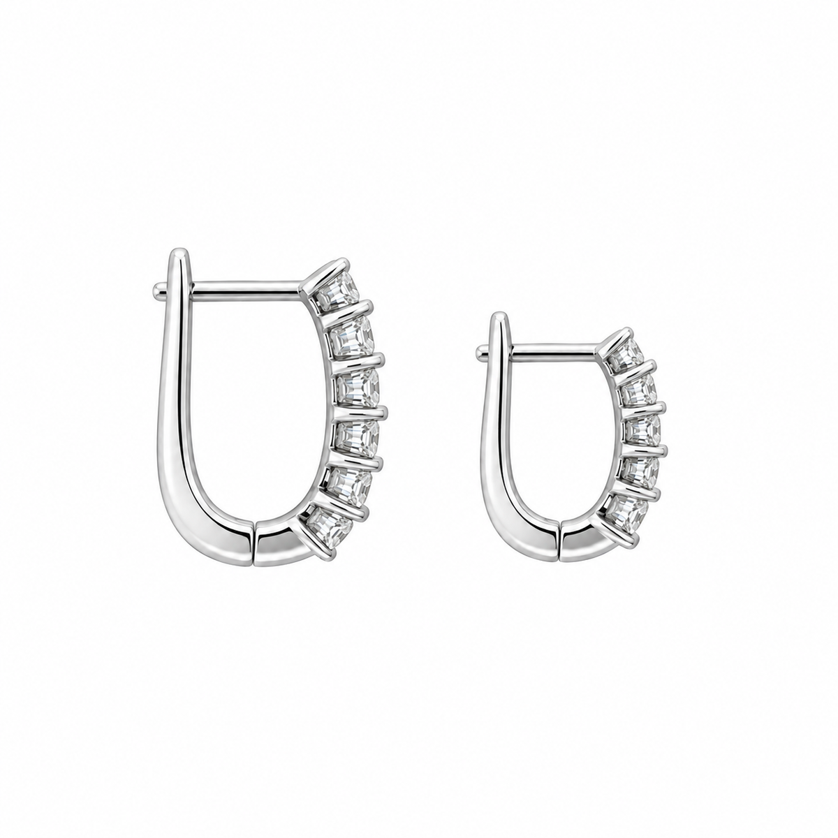 A pair of silver-toned crescent-shaped hoop earrings embellished with small clear stones along the outer curve, shown on a plain white background.